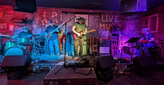 Live performance by Josh Scussell & the Electric Storm, with Josh playing guitar and singing, and the rest of the band rocking out in the background.